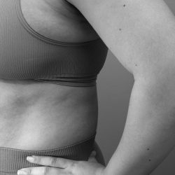 Closeup of a woman in sportswear taking a fitness pose